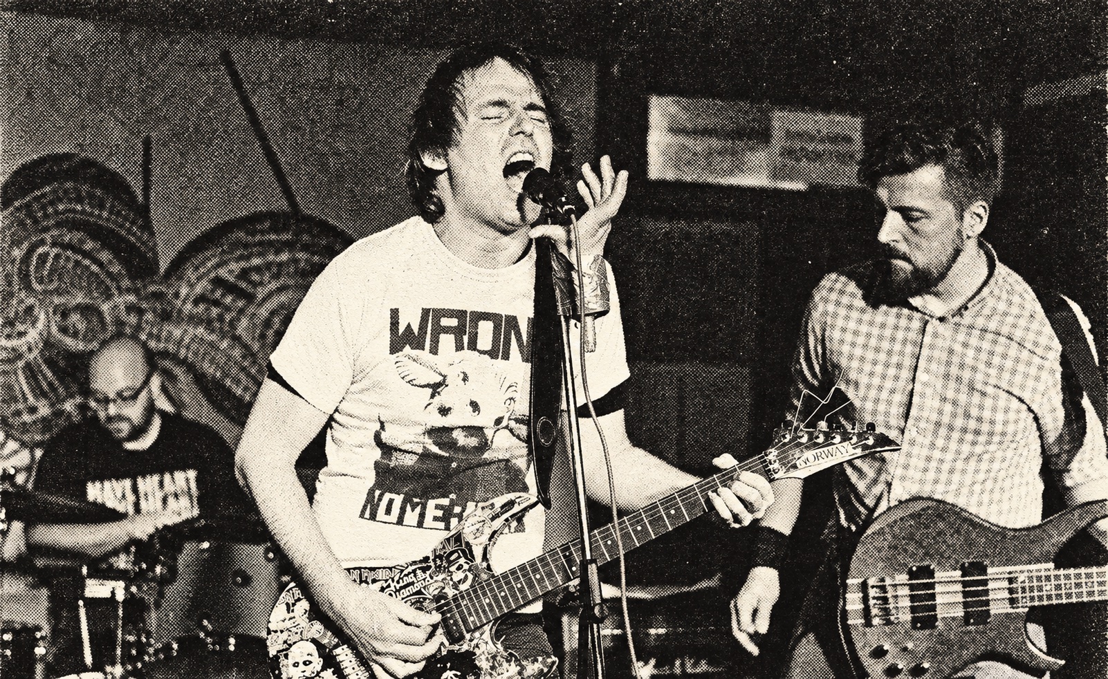 Jumpin' Juice performing close together in a club — black-and-white halftone