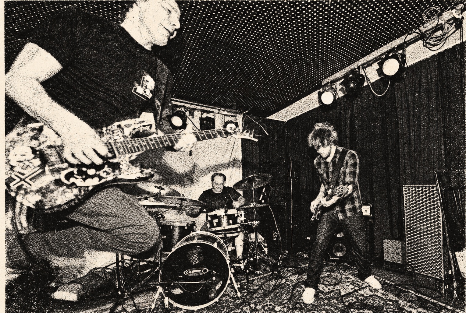 Jumpin' Juice live with the guitarist in the foreground — black-and-white halftone