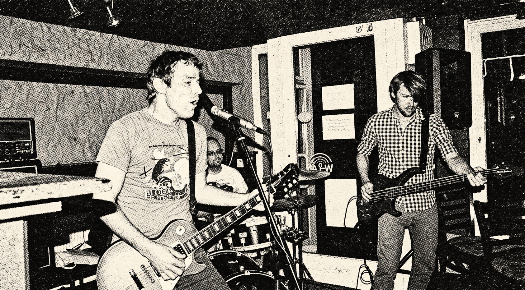 Jumpin' Juice playing in a small bar — black-and-white halftone