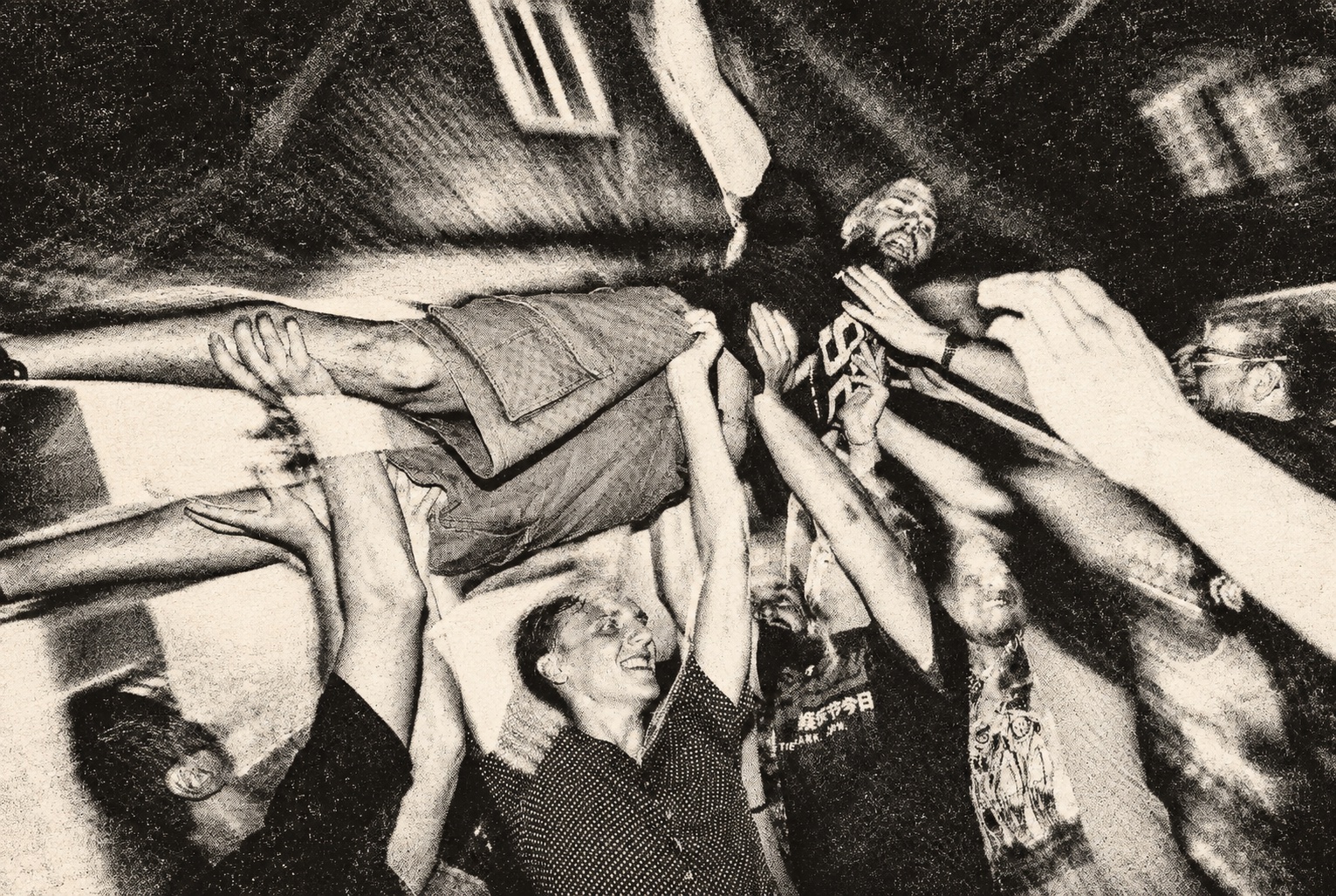 Crowdsurfing above the audience — black-and-white halftone