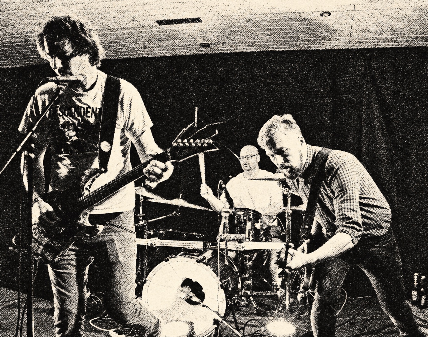 Jumpin' Juice performing together on a club stage — black-and-white halftone