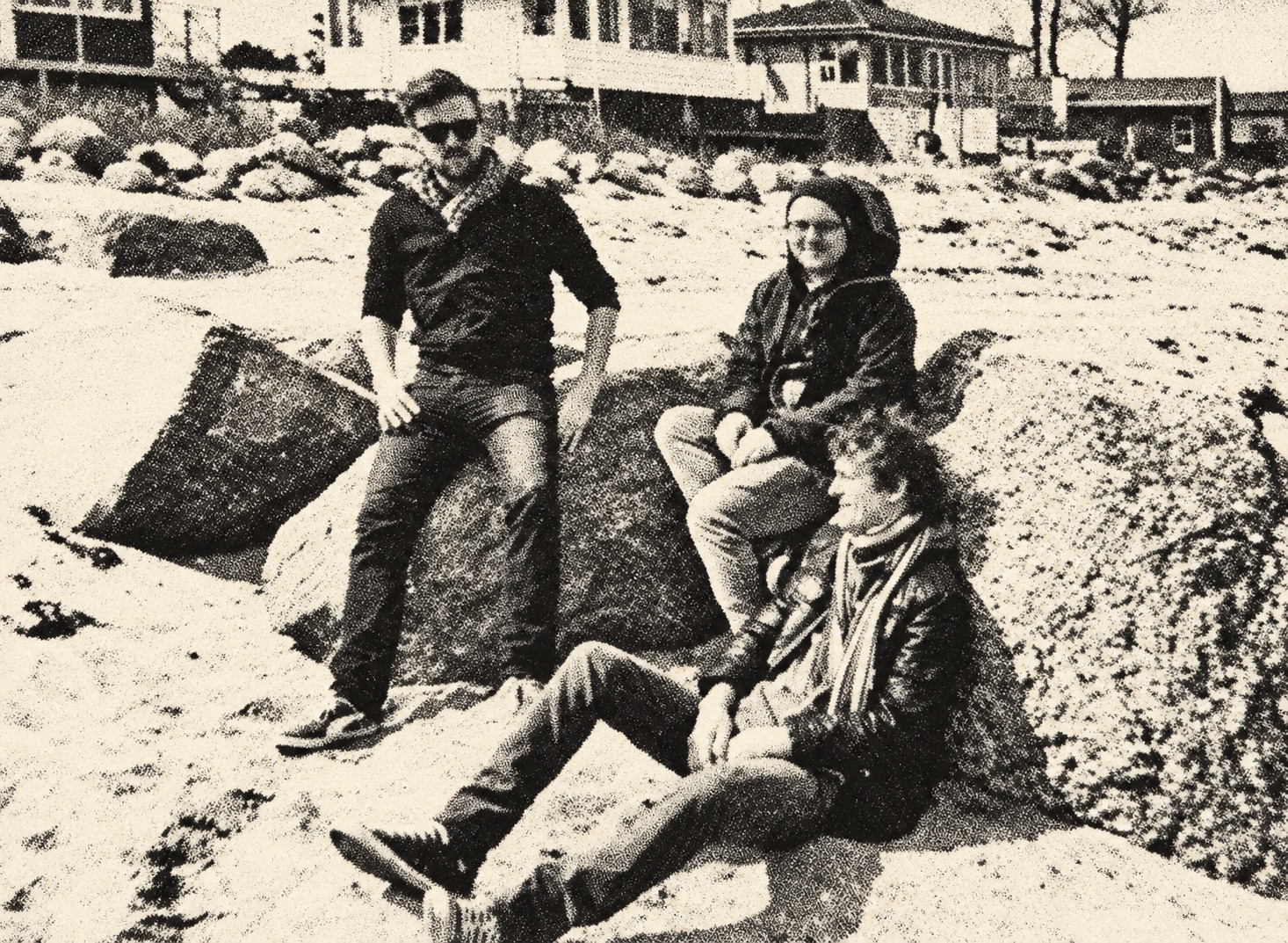 Jumpin' Juice sitting on rocks at the beach — black-and-white halftone
